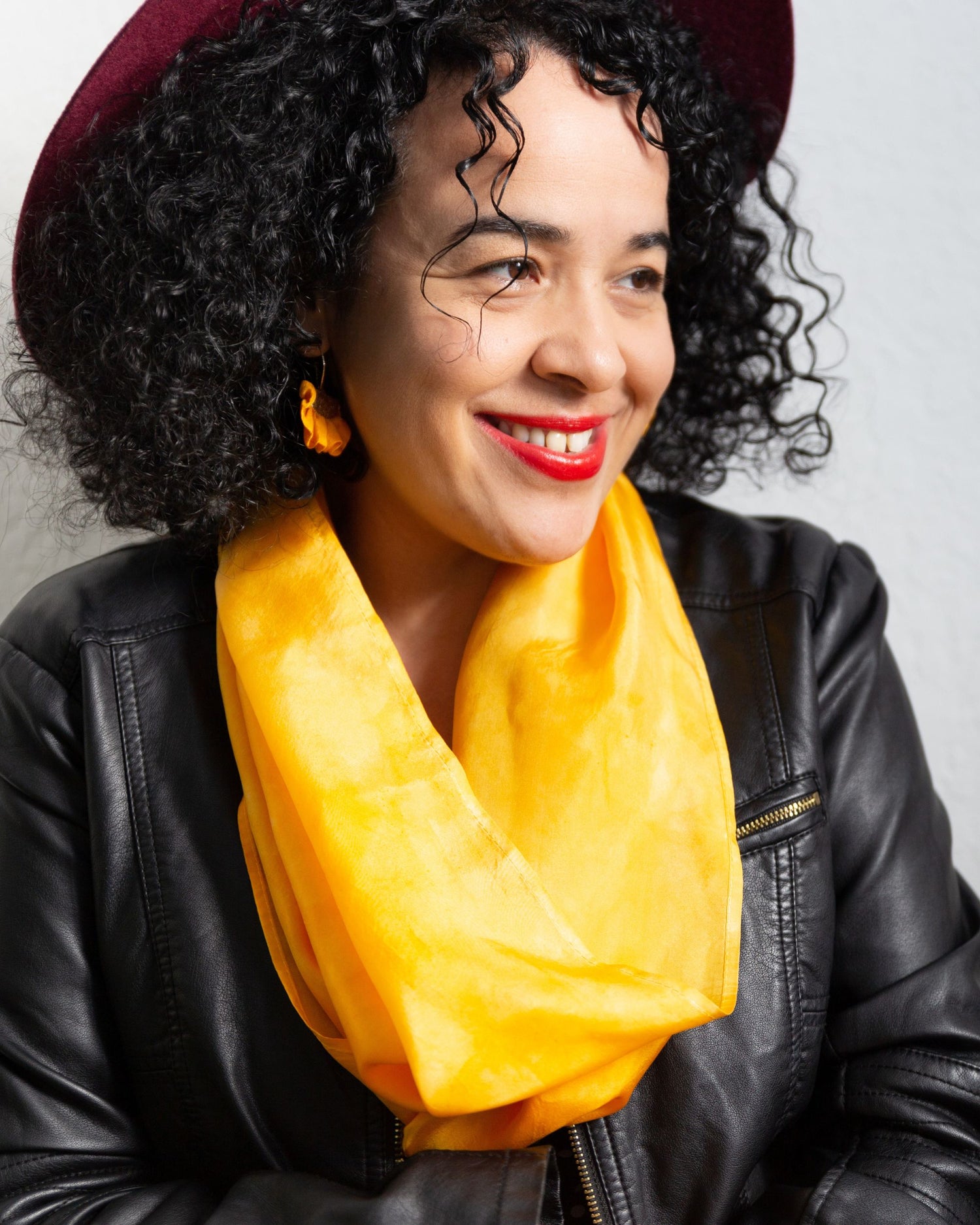 close up of infinity scarf in amethyst, worn by a black woman